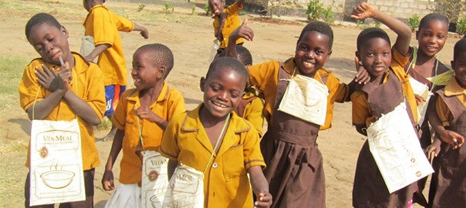 vitameal bags Children in Malawi with repurposed Vitameal bags used to carry school supplies