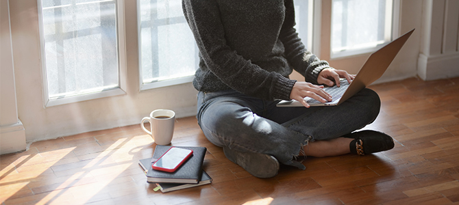 WFH Article Image 01 person sitting on the floor working on their laptop